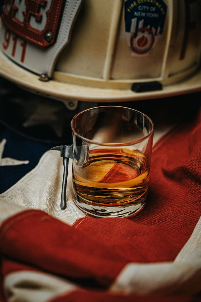 https://www.ninelineapparel.com/cdn/shop/products/american-made-whiskey-glass-with-embedded-fire-axe-544561_1024x1024.jpg?v=1696351058